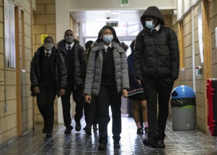 Children arrive at a school in Croydon, south London, Monday March 8, 2021. British children are returning to school on Monday after a two-month closure, part of what Prime Minister Boris Johnson said was a plan to get the country to â€œstart moving closer to a sense of normality.â€ (Aaron Chown/PA via AP)